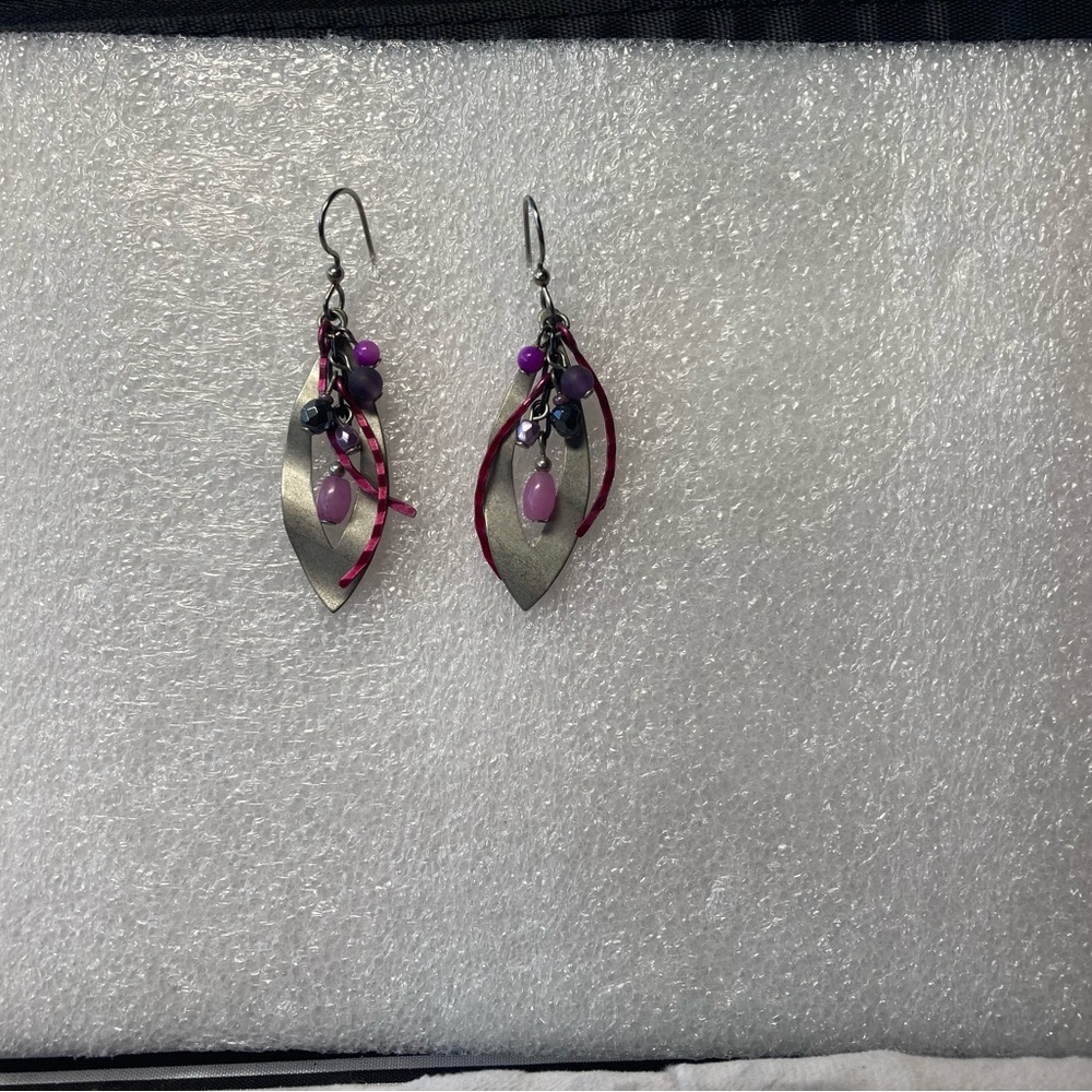 Dangling silver tone earring with lavender tone beads